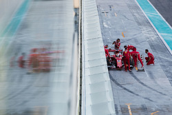 Sebastian Vettel, Ferrari SF70H, is attended to by mechanics in the pit lane