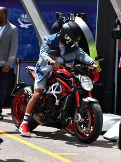 Lewis Hamilton, Mercedes AMG F1 arrives at the track on his MV Agusta motorbike