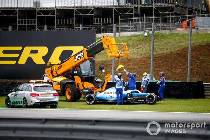 Los oficiales retiran el coche de Robert Kubica, Williams FW425, con una grúa