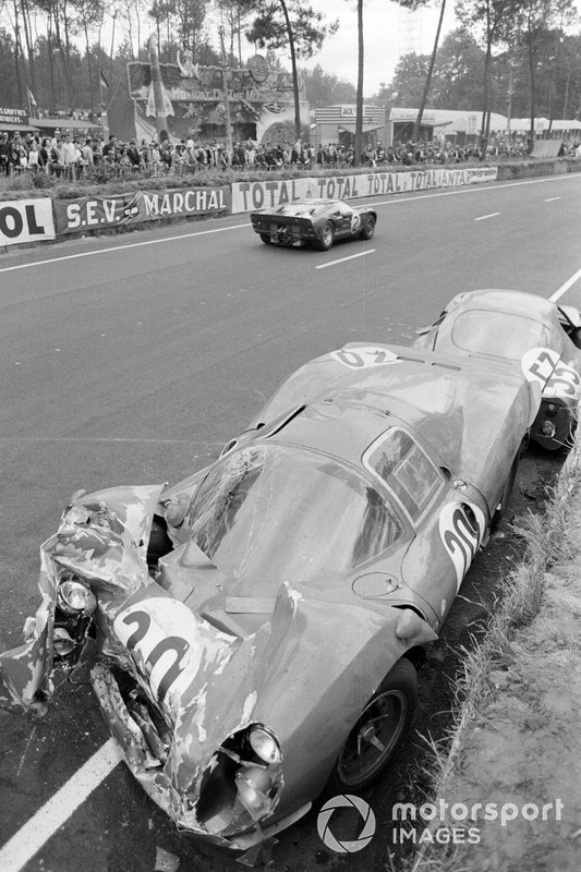 Bruce McLaren, Chris Amon, Shelby American Inc., Ford Mk II, passes the wreckage of Ludovico Scarfiotti, Mike Parkes' SpA Ferrari SEFAC, Ferrari 330 P3, and Georges Heligouin, Jean Rives' S.E.C. Automobiles C.D., C.D. SP66 Peugeot 204 