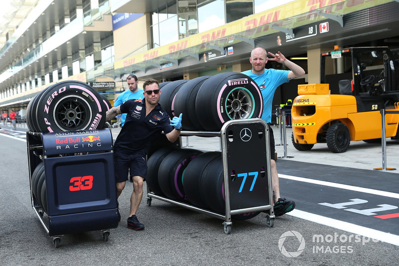 Red Bull Racing mechanic and Mercedes-AMG F1 mechanic with Pirelli tyres