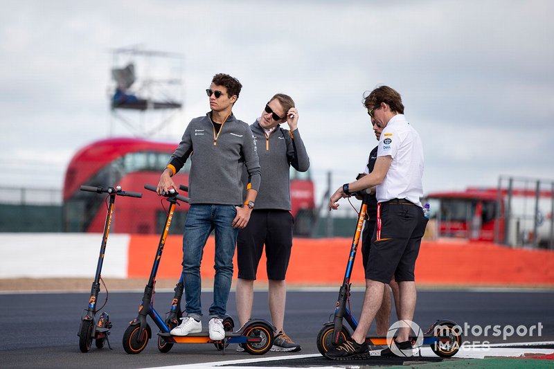 Lando Norris, McLaren walks the track on a scooter