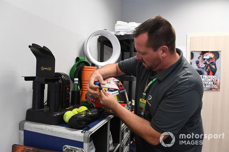 A Schuberth helmet engineer works on the helmet of Max Verstappen, Red Bull Racing