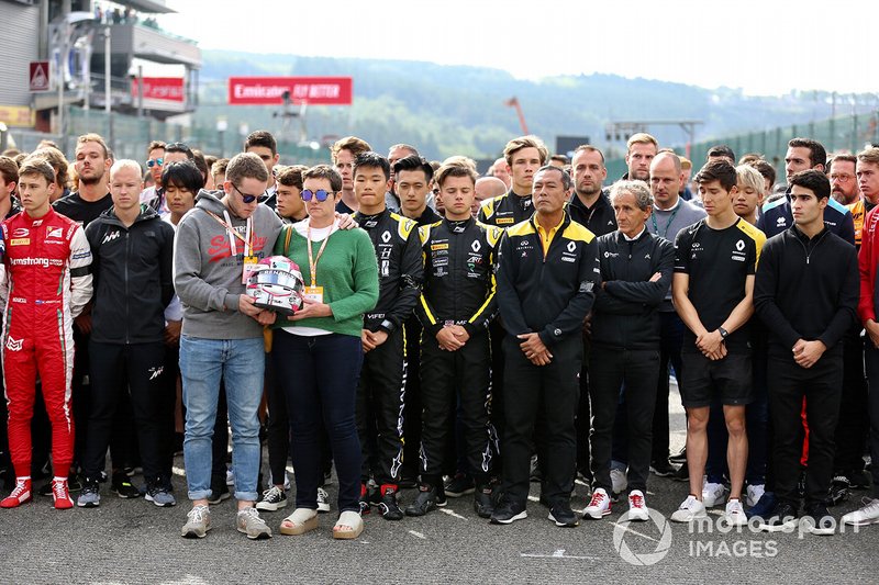 The Mother and Brother of Anthoine Hubert hold his helmet at the memorial