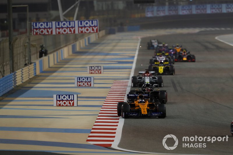 Carlos Sainz Jr., McLaren MCL34, leads Kevin Magnussen, Haas F1 Team VF-19, and Kimi Raikkonen, Alfa Romeo Racing C38
