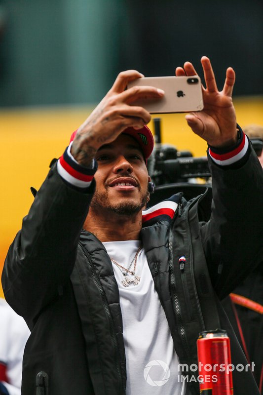 Lewis Hamilton, Mercedes AMG F1, takes a photo at the drivers parade