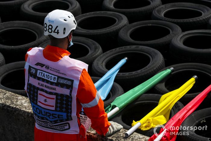 Un oficial de pista con sus banderas