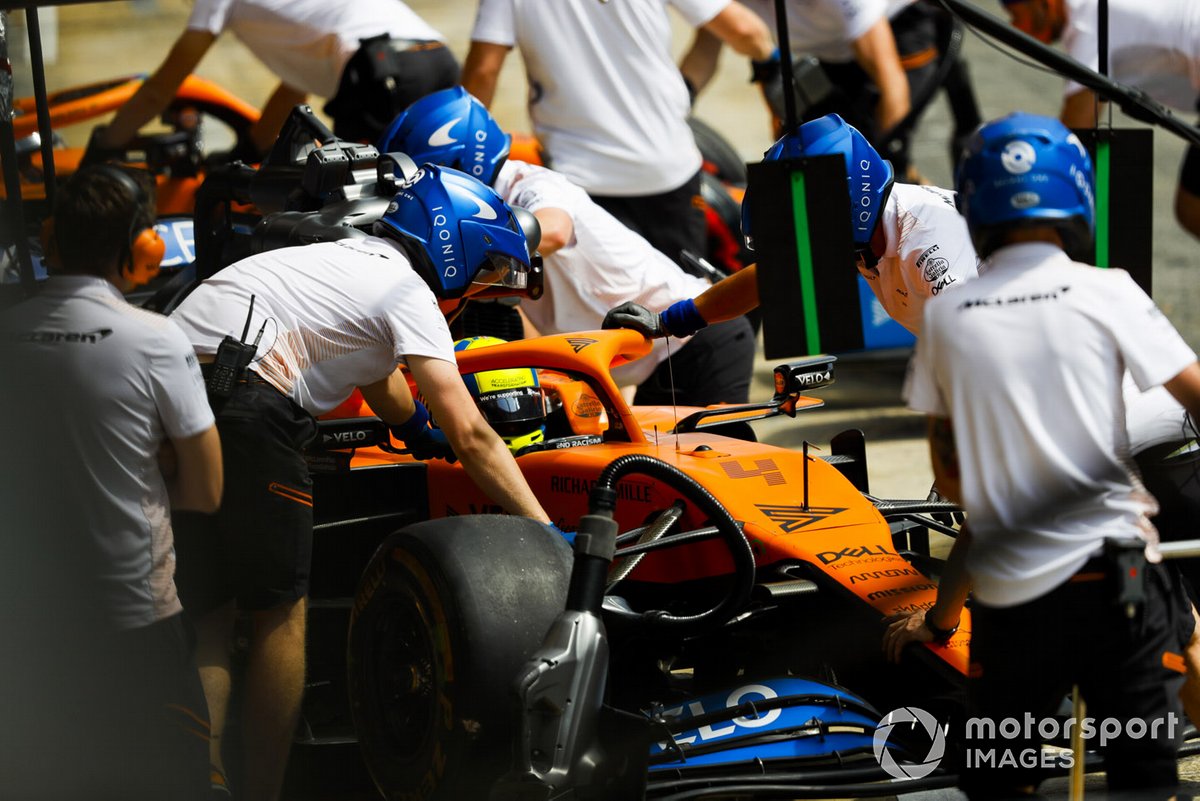 Lando Norris, McLaren MCL35, is returned to the garage