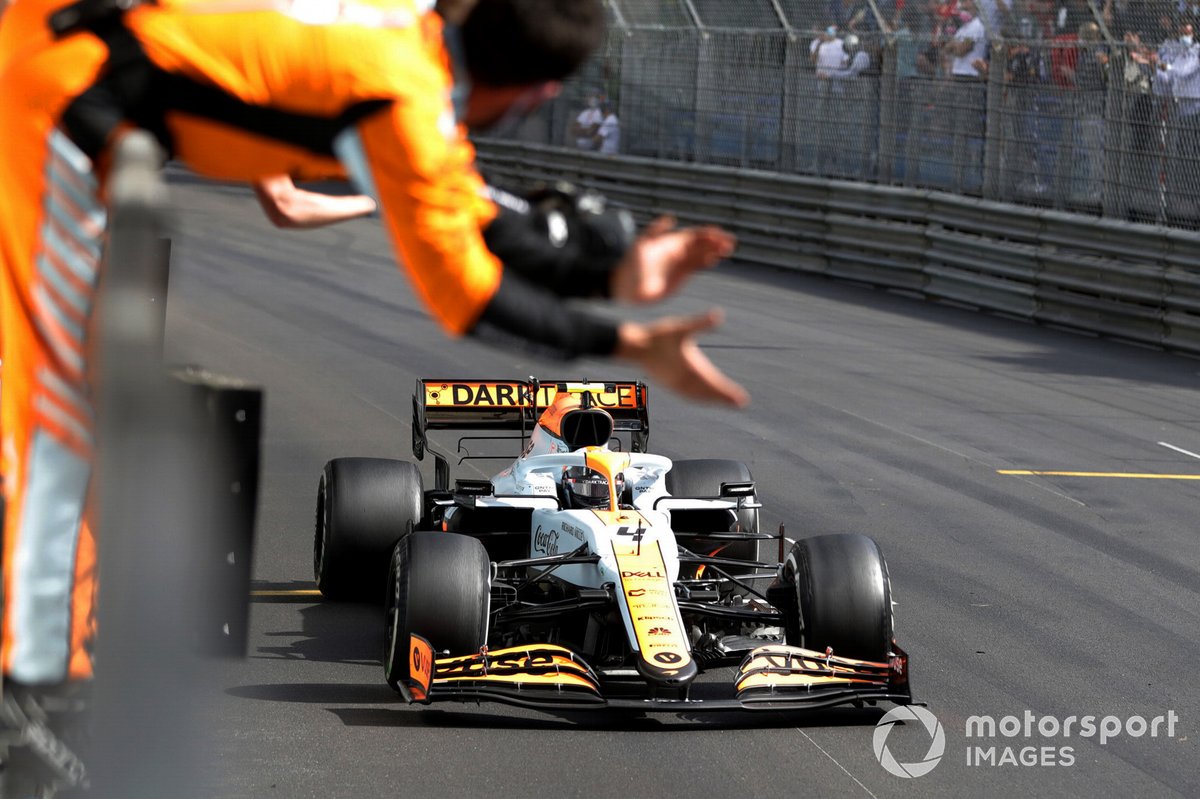 Lando Norris, McLaren MCL35M, 3rd position, crosses the line to the cheers of his team on the pit wall