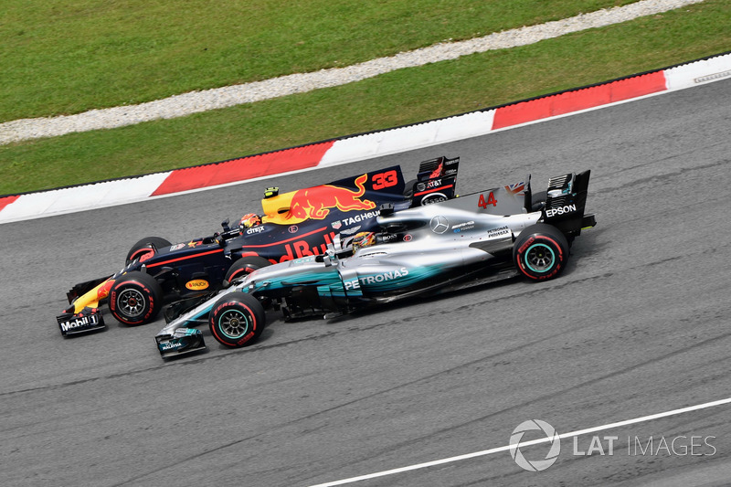 Max Verstappen, Red Bull Racing RB13 passes Lewis Hamilton, Mercedes-Benz F1 W08  for the lead