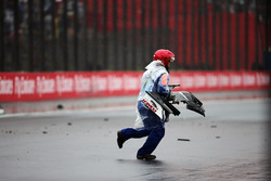 A marshall collects debris from the Sauber C35 of Marcus Ericsson, Sauber F1 Team