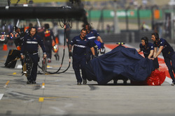 Sauber team members push the damaged Antonio Giovinazzi Sauber C36