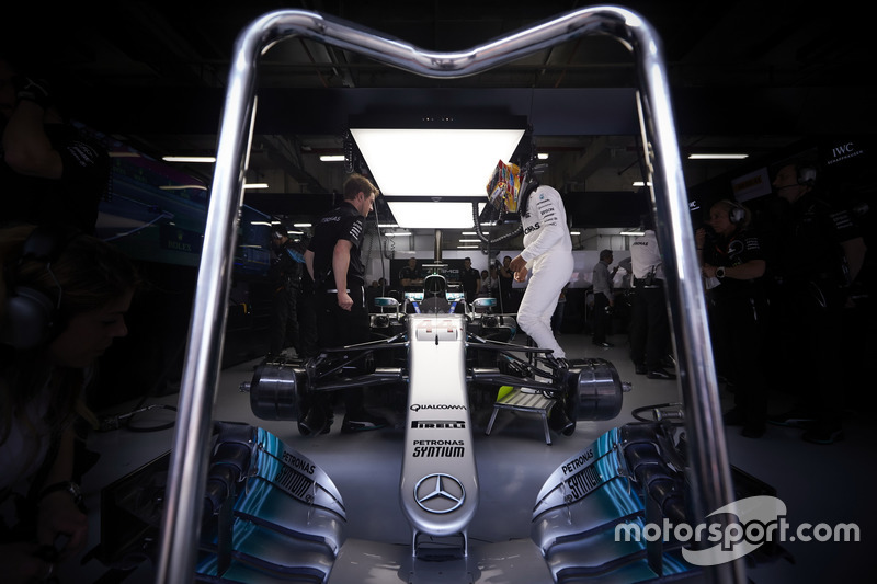 Lewis Hamilton, Mercedes AMG, climbs in to his car