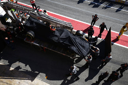The McLaren MCL32 of Fernando Alonso is returned to the pits on a truck