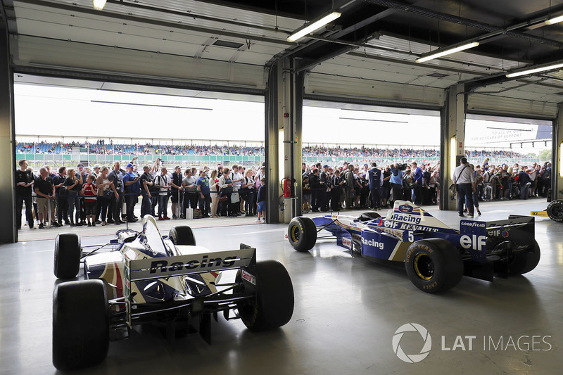 Fans view a garage filled, classic Williams F1 machinery