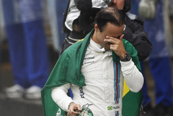 Felipe Massa, Williams, carries a Brazilian flag as he walks back to his garage in tears after crash