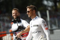 Jenson Button walks in the pit lane with trainer Mike Collier