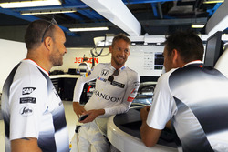 Jenson Button, McLaren talks to colleagues in the garage