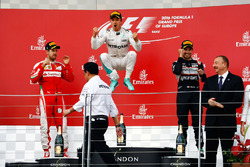 The podium (L to R): Sebastian Vettel, Ferrari, second; Nico Rosberg, Mercedes AMG F1, race winner;