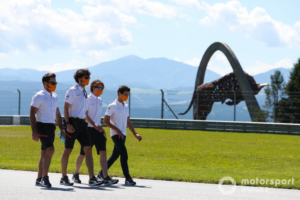 Lando Norris, McLaren, walks the track with colleagues