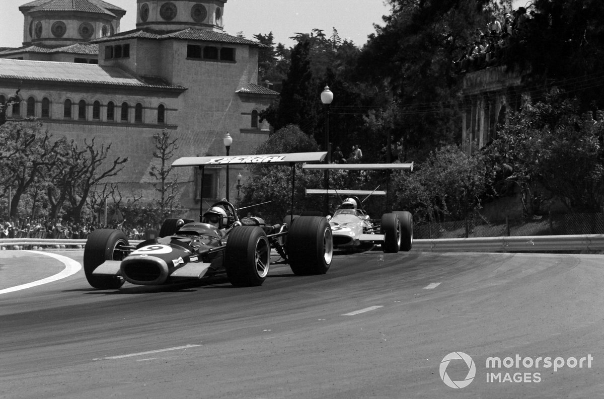 Pedro Rodriguez, BRM P126, leads Denny Hulme, McLaren M7A Ford