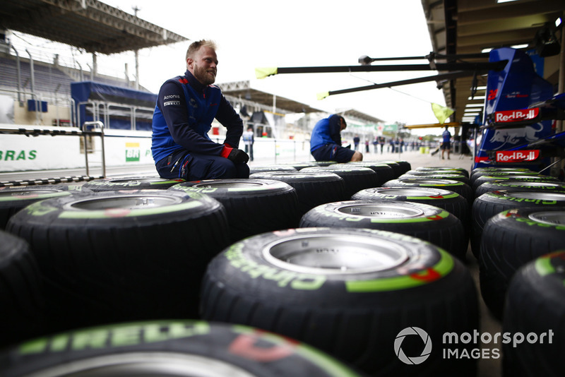 A Toro Rosso mechanic works on Pirelli tyres