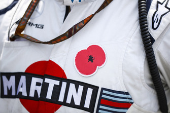 A poppy on the overalls of a Williams team member.