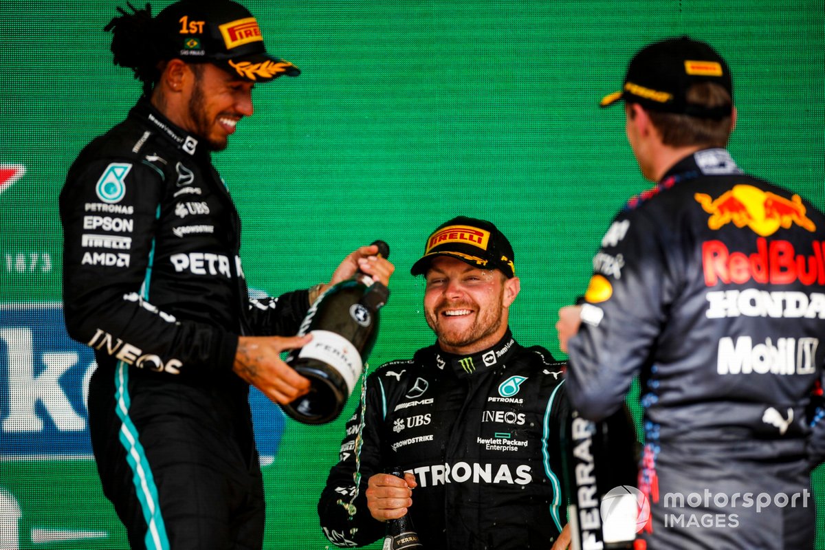 Lewis Hamilton, Mercedes, 1st position, Valtteri Bottas, Mercedes, 3rd position, and Max Verstappen, Red Bull Racing, 2nd position, celebrate on the podium