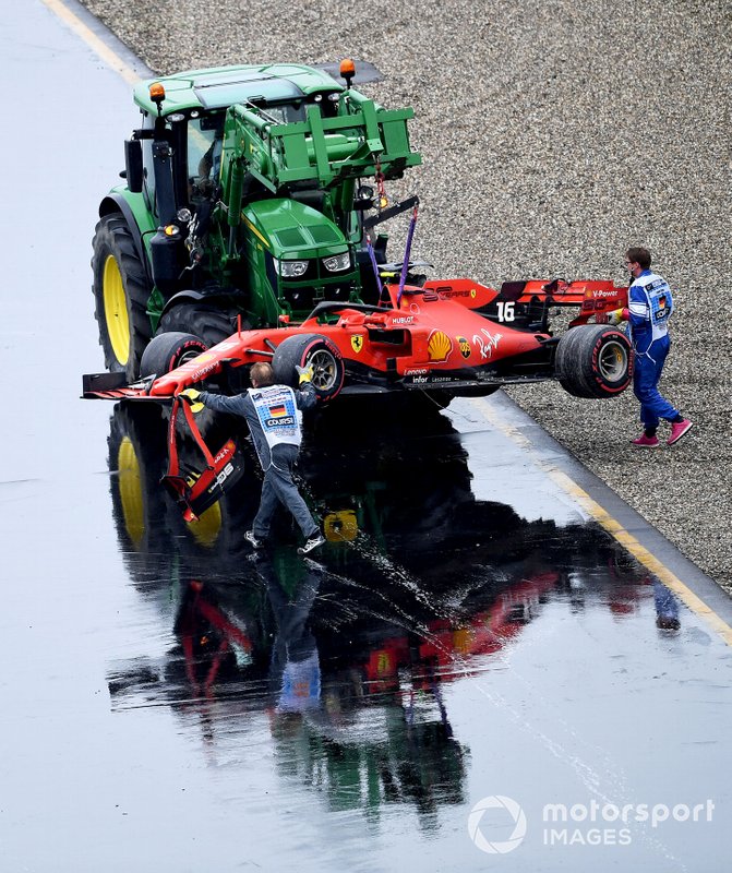 Marshals remove the damaged car of Charles Leclerc, Ferrari SF90