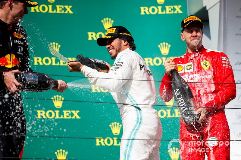 Max Verstappen, Red Bull Racing, 2nd position, Lewis Hamilton, Mercedes AMG F1, 1st position, and Sebastian Vettel, Ferrari, 3rd position, celebrate with Champagne on the podium