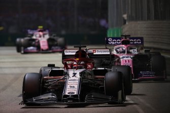 Kimi Raikkonen, Alfa Romeo Racing C38, leads Sergio Perez, Racing Point RP19, and Lance Stroll, Racing Point RP19