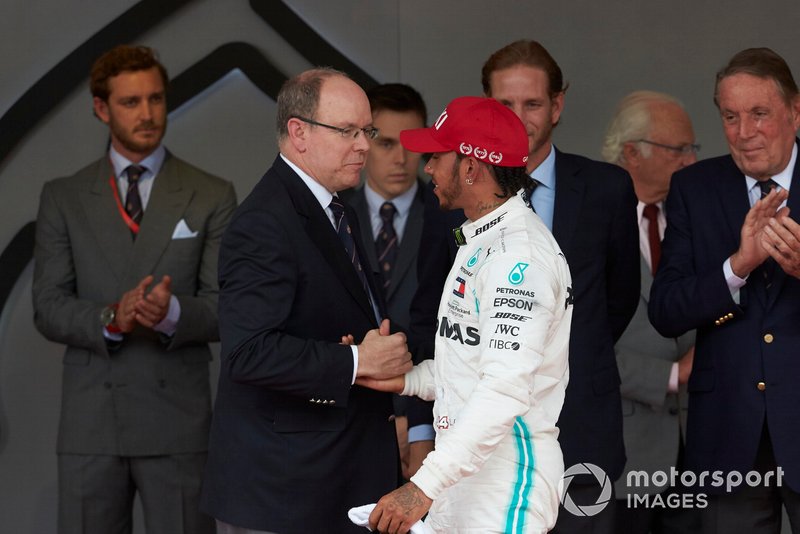 Prince Albert II of Monaco congratulates Lewis Hamilton, Mercedes AMG F1, 1st position, on the podium