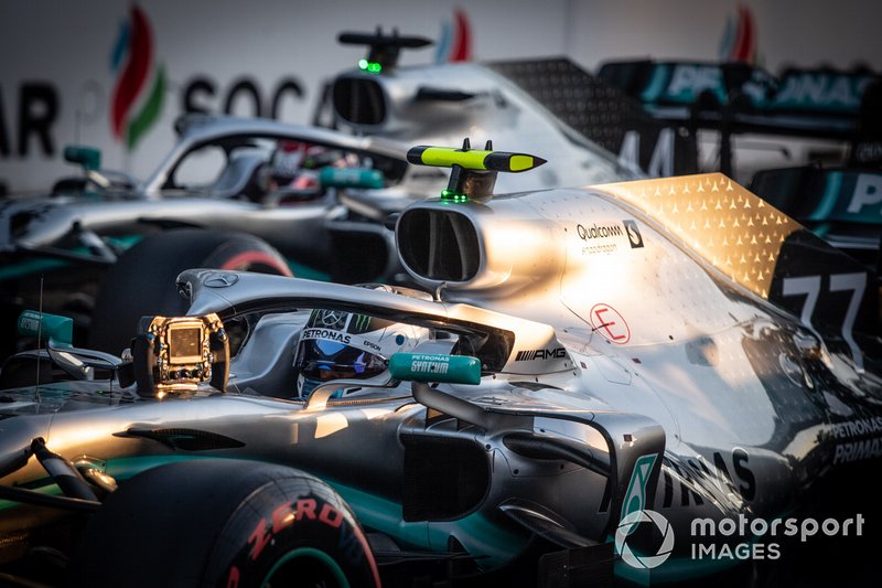 Valtteri Bottas, Mercedes AMG W10, and Lewis Hamilton, Mercedes AMG F1 W10, arrive on the grid after Qualifying