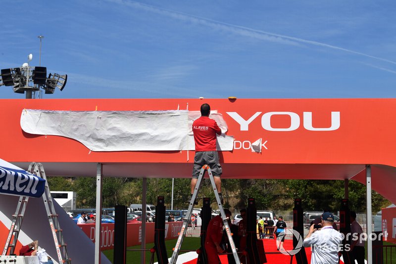 Workers installing branding in paddock