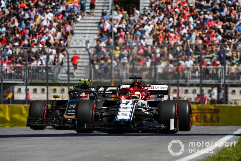Kimi Raikkonen, Alfa Romeo Racing C38, leads Kevin Magnussen, Haas VF-19