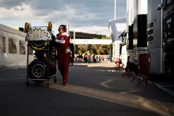 Ferrari mechanic with Pirelli tyres in the paddock