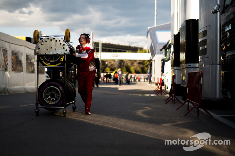 Ferrari mechanic with Pirelli tyres in the paddock