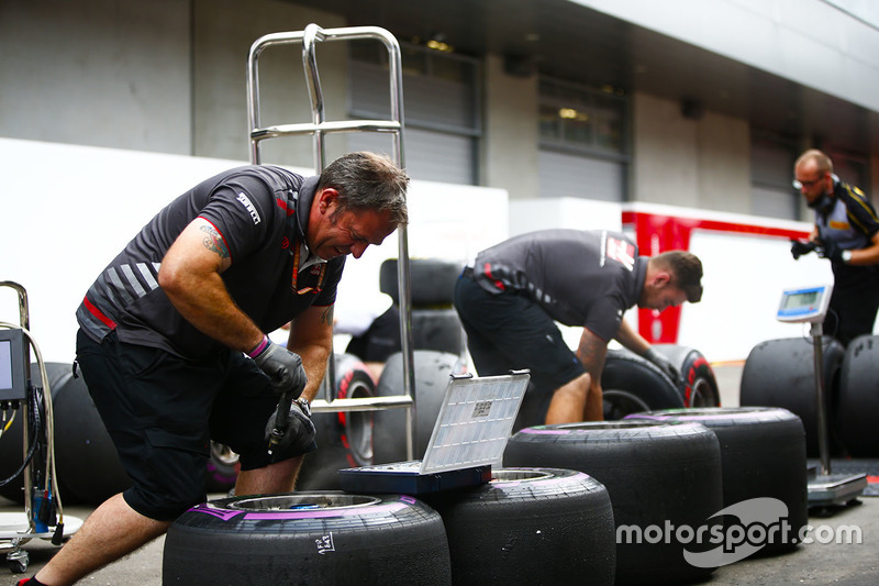 Haas engineers work on some tyres