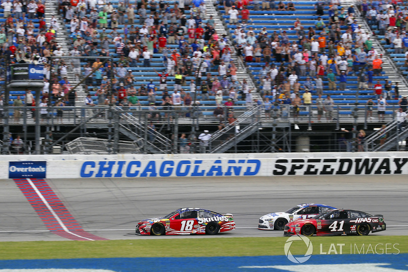 Kyle Busch, Joe Gibbs Racing, Toyota Camry Skittles Red White & Blue drives under the checkered flag to win