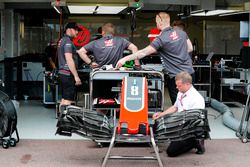 Haas team members at work on the Romain Grosjean, Haas F1 Team VF-18 in the pit lane