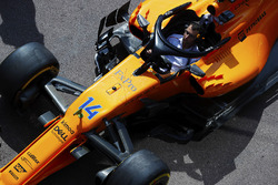 A McLaren mechanic sits in the Fernando Alonso McLaren MCL33 during a practice pit stop