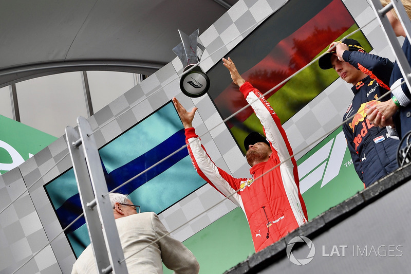 Race winner Sebastian Vettel, Ferrari celebrates with the trophy on the podium