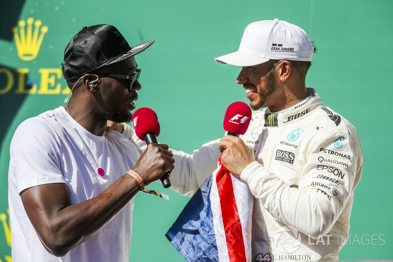 Usain Bolt interviews Race winner Lewis Hamilton, Mercedes AMG F1, on the podium