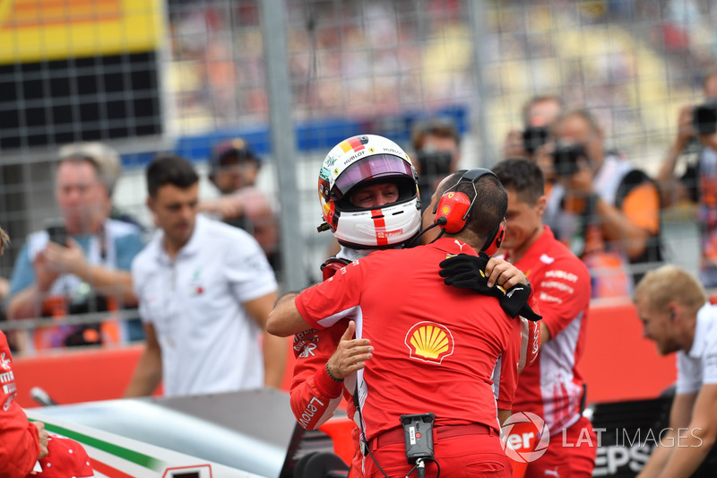 Pole sitter Sebastian Vettel, Ferrari celebrates in parc ferme with engineer