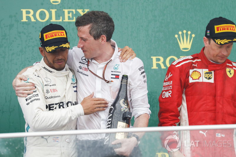 Lewis Hamilton, Mercedes AMG F1, 1st position, celebrates with the Mercedes Constructors trophy delegate alongside Kimi Raikkonen, Ferrari, 2nd position, on the podium