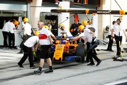 Fernando Alonso, McLaren MCL33 Renault, is returned to the garage by engineers