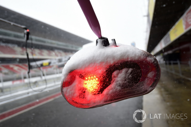 Ferrari pit stop lights as snow stops testing on day three