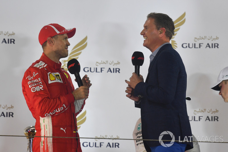 Sebastian Vettel, Ferrari talks with David Coulthard, on the podium