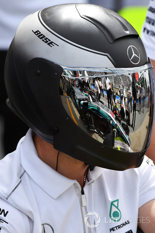 Mercedes AMG F1 mechanic with reflection in helmet