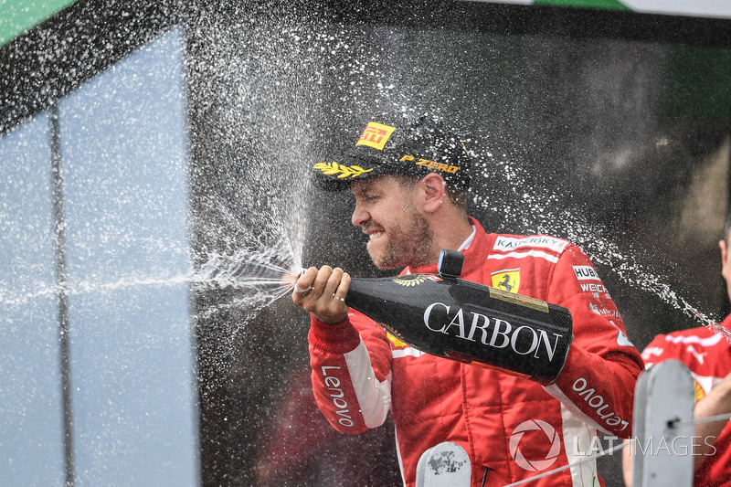 Sebastian Vettel, Ferrari celebrates on the podium with the champagne